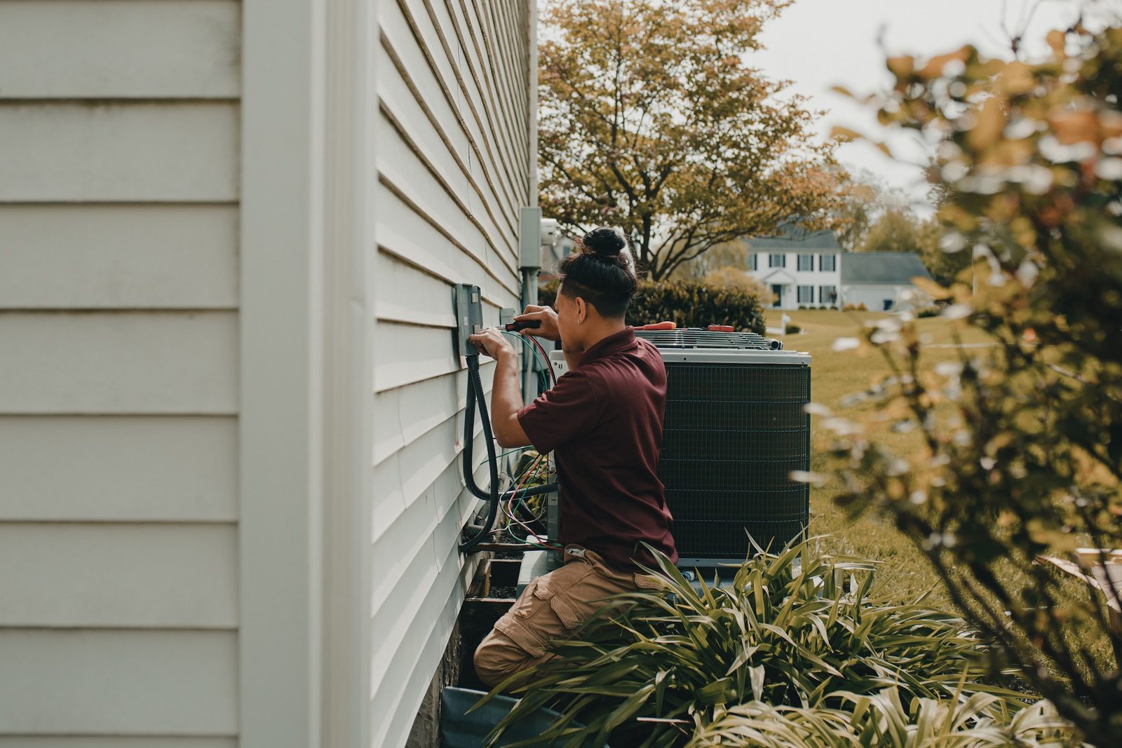 Topline Heating & Air technician wiring the disconnect for a new outdoor unit during a home HVAC system replacement